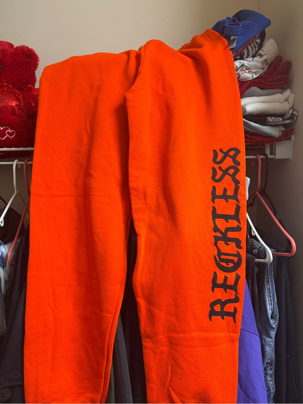 Young & Reckless Orange Sweatpants with Black 'RECKLESS' Side Graphic